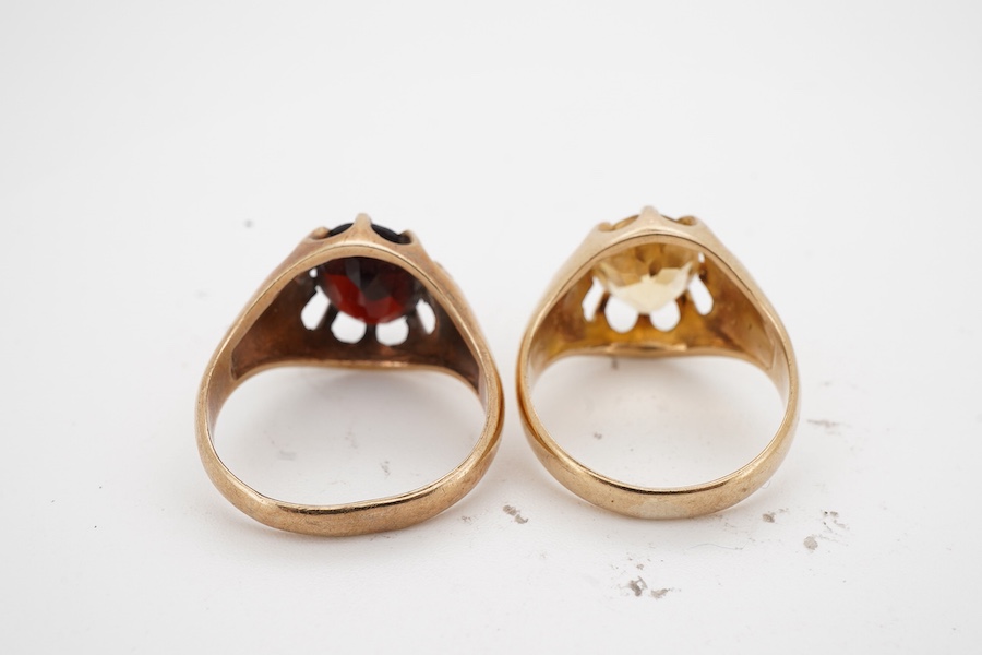 Two gem-set rings, early 20th century, one set with an oval citrine, the other with an oval garnet, each mounted in 9ct gold, sizes M1/2 and N respectively, each with British hallmark, combined gross weight approximately